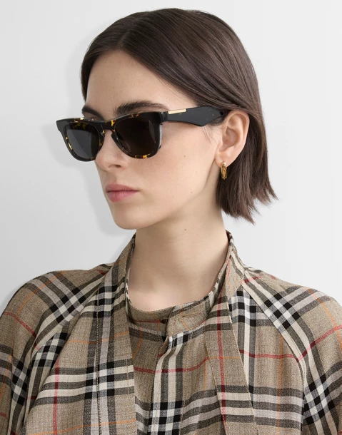 Woman model wearing Burberry sunglasses.