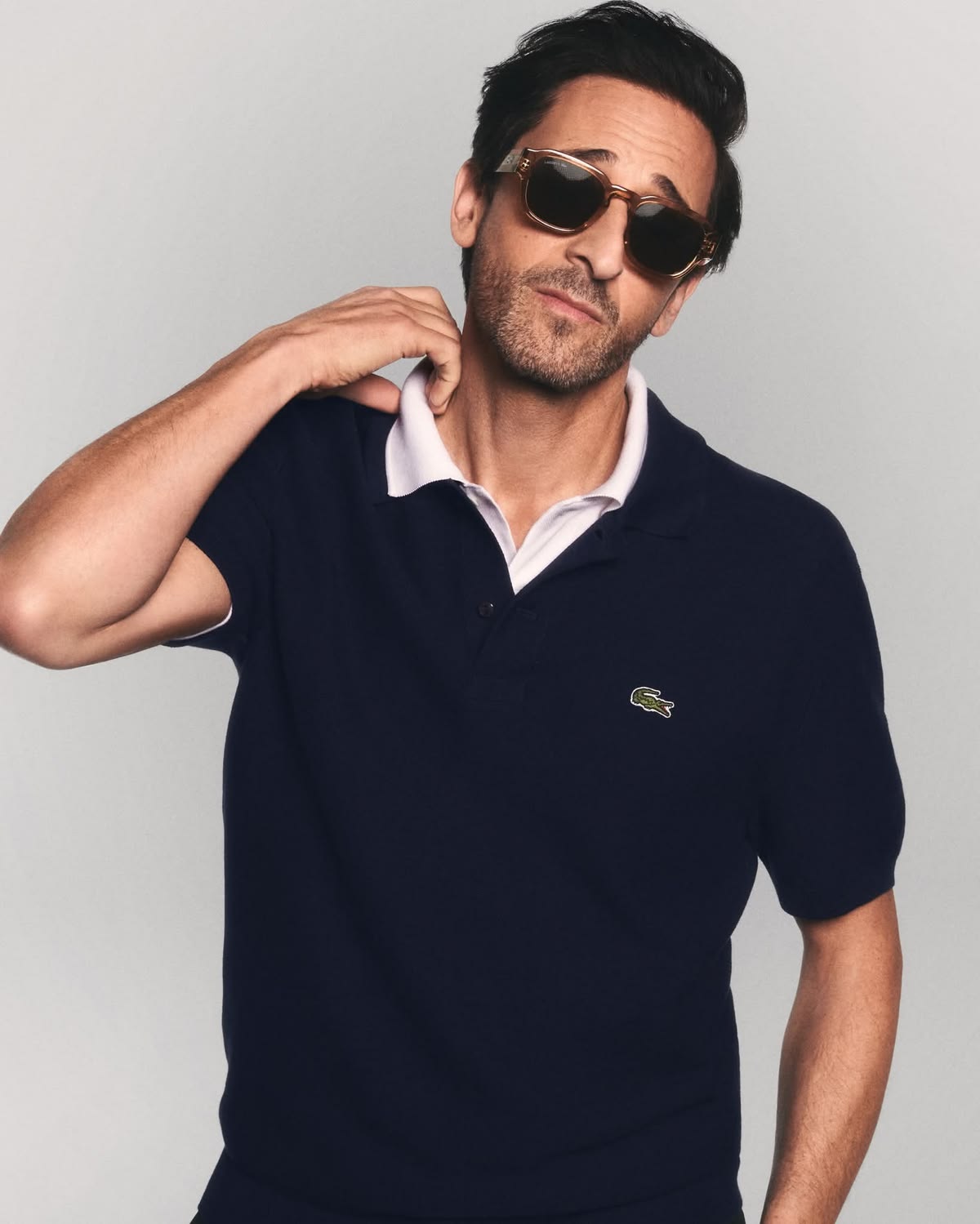 Male wearing Lacoste sunglasses.