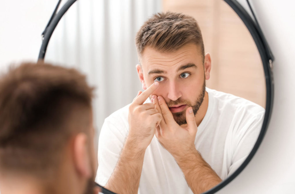 Man preparing to insert contact lenses